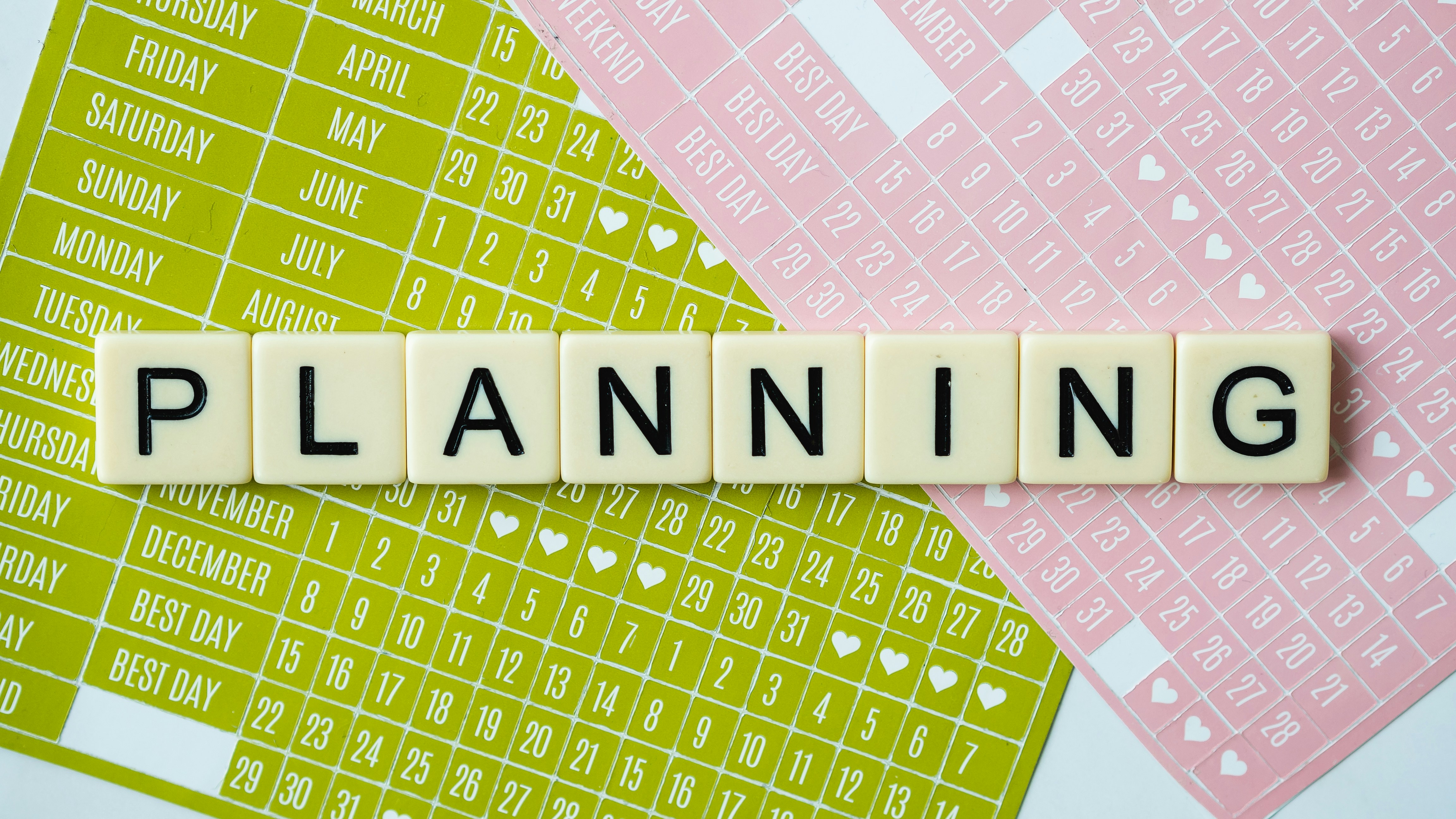 Person planning with calendar and notebook