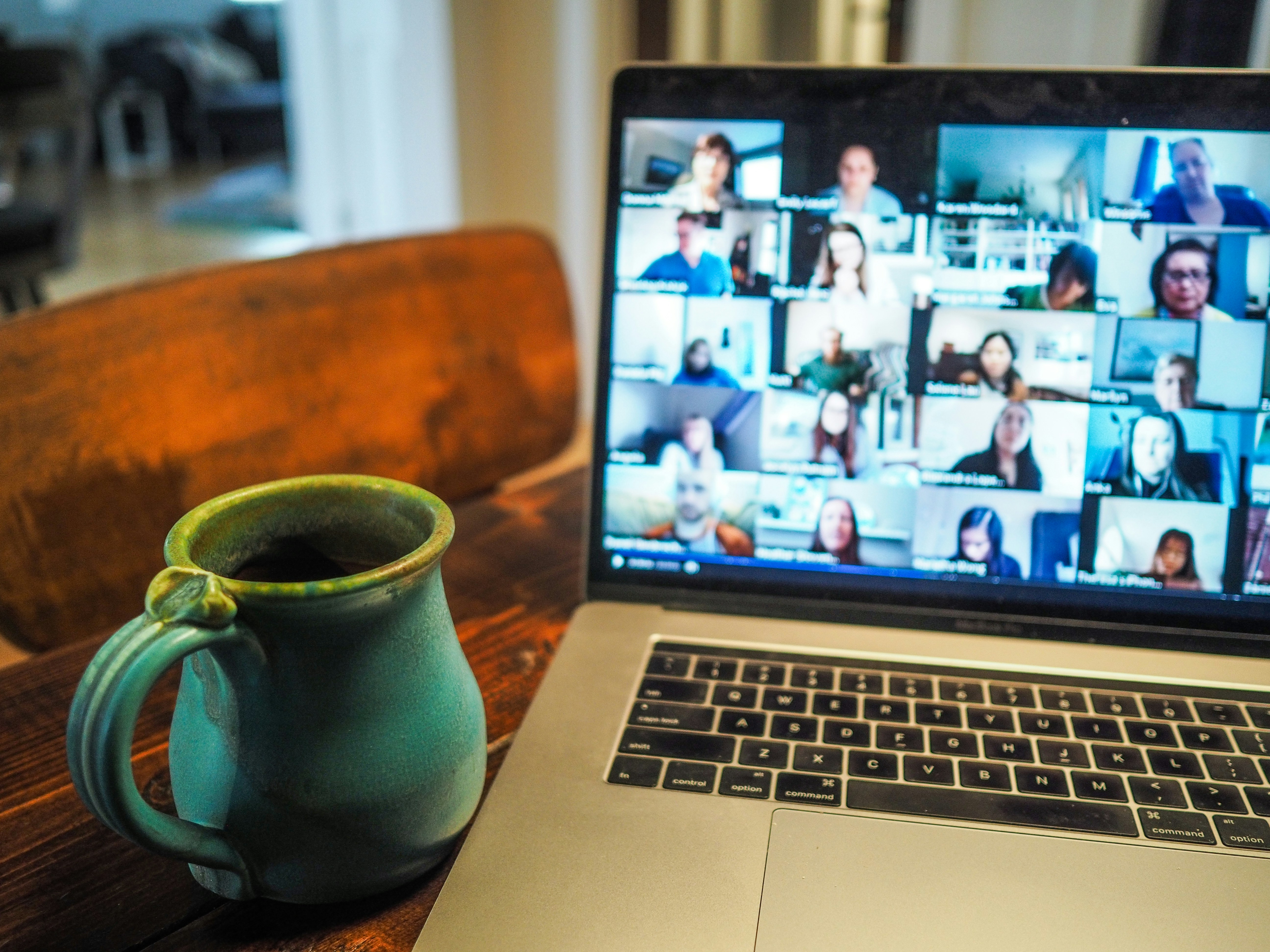 Person attending an online business program on laptop